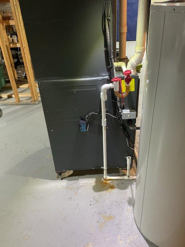 Completed comprehensive cooling system maintenance on residential HVAC unit. Performed thorough inspection of furnace/air handler assembly, verified proper electrical connections at control terminal block with multi-circuit wiring configuration, and confirmed all safety shut-off valves and PVC drainage lines were functioning correctly. All components operating within normal parameters with no deficiencies noted.