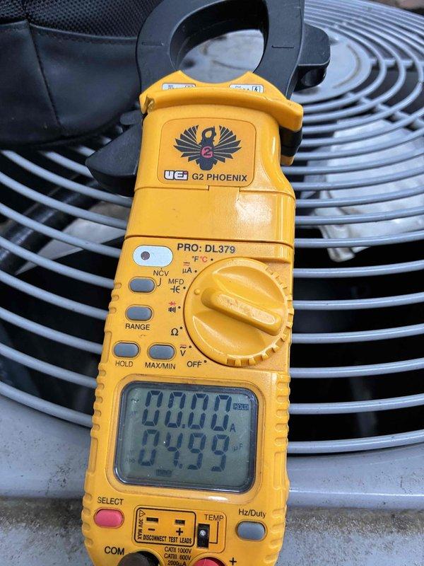 # HVAC Cooling System Tune-Up Completed

Performed comprehensive preventive maintenance on residential air conditioning system. Conducted thorough electrical diagnostics using clamp meter to verify proper amperage draw on condenser fan motor and compressor circuit. Measured voltage and current values at control board and confirmed all electrical connections were secure and within manufacturer specifications. Inspected condenser unit fan assembly and protective grille for proper operation. All system components tested and operating normally with readings documented for future reference.