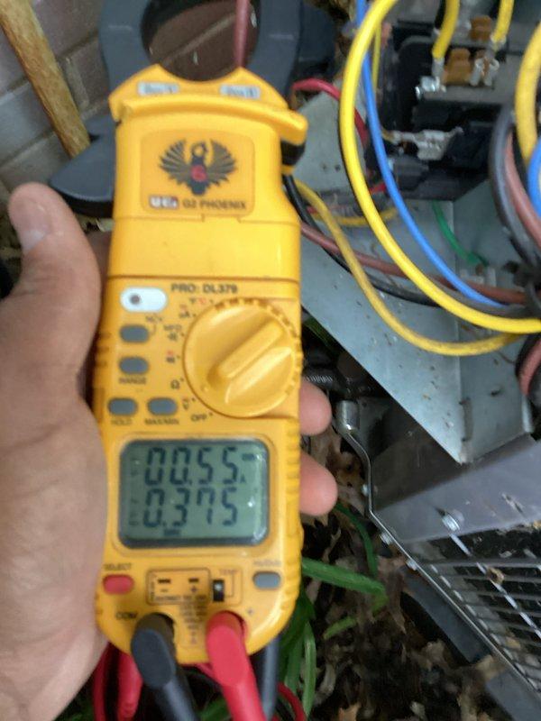 # HVAC Cooling System Tune-Up Completed

Performed comprehensive preventive maintenance on residential air conditioning system. Conducted thorough electrical diagnostics using clamp meter to verify proper amperage draw on condenser fan motor and compressor circuit. Measured voltage and current values at control board and confirmed all electrical connections were secure and within manufacturer specifications. Inspected condenser unit fan assembly and protective grille for proper operation. All system components tested and operating normally with readings documented for future reference.