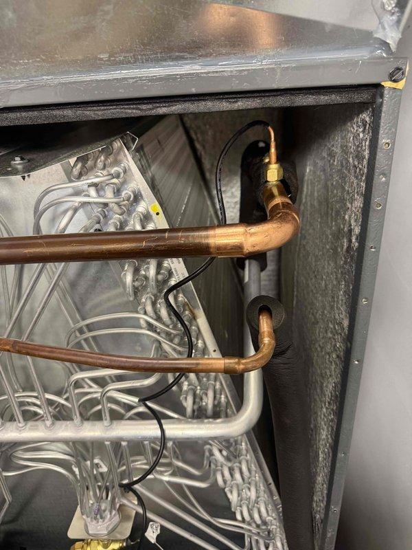 Completed warranty coil replacement on residential air handler system. Removed and replaced defective evaporator coil assembly, installed new copper refrigerant line connections with proper brazing and soldered joints, and recharged system with refrigerant to manufacturer specifications. Verified all connections for proper seal, tested system operation, and confirmed cooling performance upon completion.