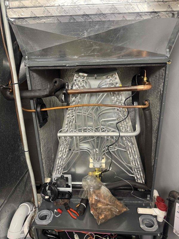 Completed warranty coil replacement on residential air handler system. Removed and replaced defective evaporator coil assembly, installed new copper refrigerant line connections with proper brazing and soldered joints, and recharged system with refrigerant to manufacturer specifications. Verified all connections for proper seal, tested system operation, and confirmed cooling performance upon completion.