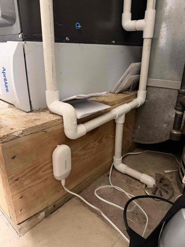 Completed installation and connection of water sensor and frost sensor to Resideo 8000 series thermostat system. Both sensors were properly wired and mounted in utility area near HVAC equipment and condensate drain lines to provide freeze protection and water leak detection monitoring.