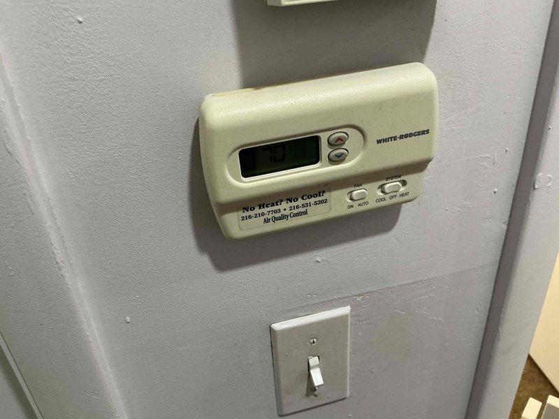 Conducted comprehensive estimate evaluation for furnace replacement in residential property. Assessed existing brown/tan metal furnace unit with side-mounted humidifier system, documented current thermostat configuration (White-Rodgers digital unit), and evaluated overall HVAC system layout including existing ductwork and mechanical room conditions. Provided homeowner with multiple furnace replacement options based on equipment age, configuration, and space requirements.