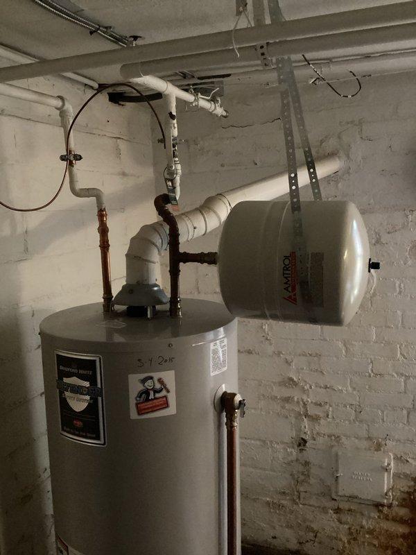 Completed scheduled plumbing maintenance visit for residential water heater system. Performed routine inspection of water heater unit, expansion tank, and associated plumbing connections including copper supply lines and PVC discharge piping. Verified proper operation of system components, checked for leaks or signs of deterioration, and documented current condition of equipment with photographic records. All components found to be functioning within normal parameters.