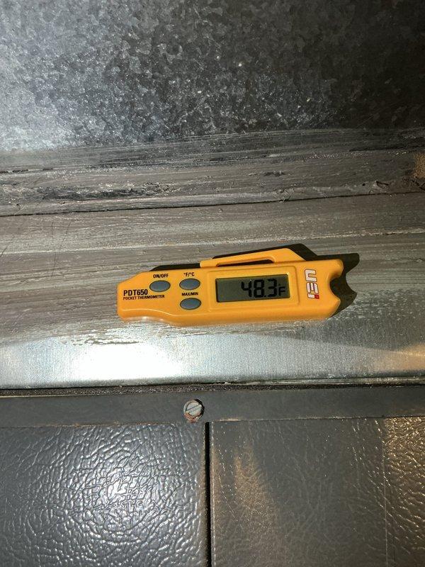 Completed cooling system tune-up on residential HVAC unit. Inspected outdoor condensing unit, verified refrigerant lines and electrical connections, cleared debris from drain pan, and measured supply air temperature at 48.3°F indicating proper system operation. Unit operating within normal parameters upon completion of preventive maintenance service.