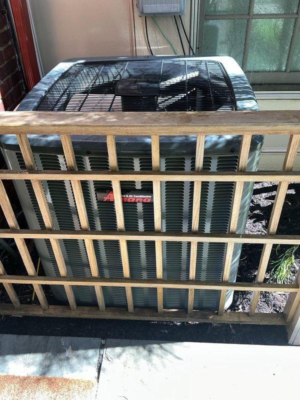 Completed comprehensive cooling system maintenance on residential HVAC unit. Performed interior inspection of air handler components including Honeywell control module, transformer, and refrigerant line connections. Inspected outdoor condenser unit with protective wooden cage enclosure, verified fan assembly operation, and confirmed proper equipment function on concrete pad. All components found in satisfactory operating condition with routine maintenance procedures completed.