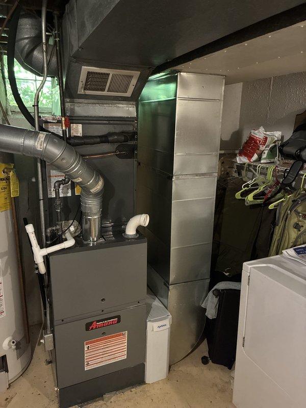 # HVAC System Installation

Completed full residential HVAC system installation featuring an 80% efficiency Amana furnace with matching air conditioning unit. Installed new furnace in utility room basement location with proper ductwork connections, including supply and return air plenums with metal ductwork distribution throughout the structure. Mounted air handler components near ceiling with secure support and verified all mechanical connections. Performed system startup procedures and diagnostic testing using calibrated instruments to verify proper operation, confirming system temperature differentials and electrical parameters within manufacturer specifications. All equipment operational and ready for service.