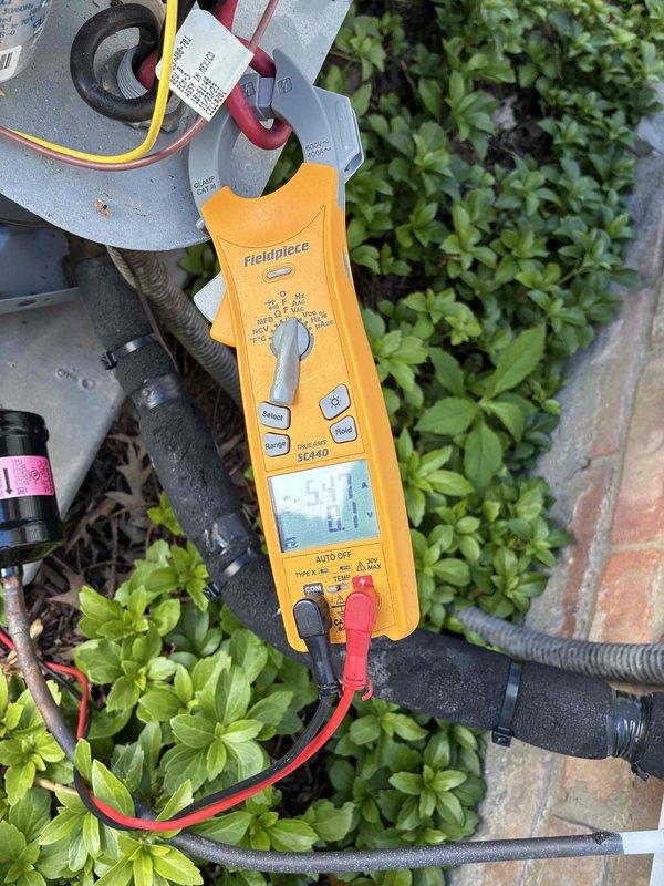 Performed routine HVAC tune-up service on outdoor condensing unit. Replaced air filter with new pleated media filter and conducted electrical diagnostics using clamp meter to verify proper voltage and amperage at capacitor and system components. All measurements within normal operating parameters; system operating efficiently.