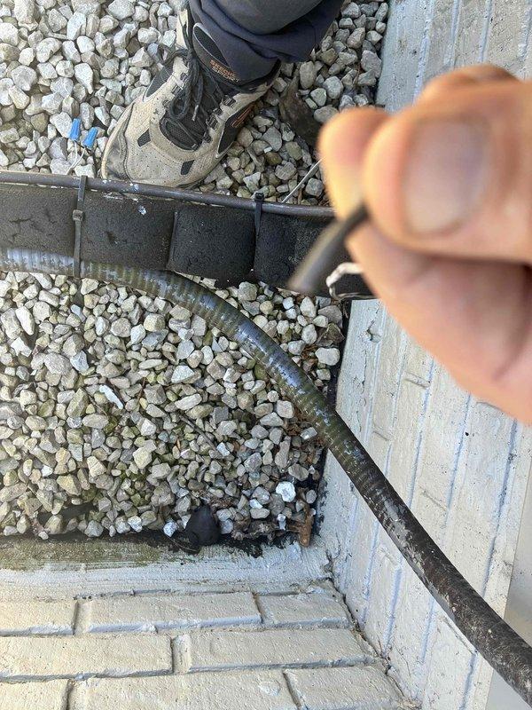 Returned to property to complete thermostat wire repair. Located and retrieved damaged wire section from exterior gravel area near foundation where conduit runs underground. Replaced faulty wire segment and secured new wiring through existing conduit pathway, ensuring proper connection and system functionality.