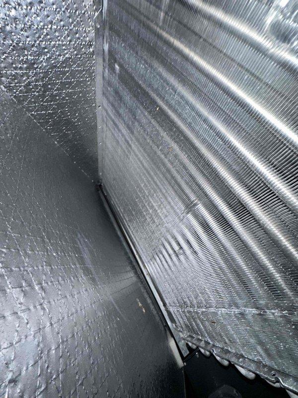Performed comprehensive preventive maintenance on residential cooling system. Inspected evaporator coil assembly housed within insulated air handler unit, confirming proper fin condition and heat exchange surface integrity. Verified condensate drain line positioning and clearance at coil base. All components found in satisfactory operating condition with no deficiencies noted.