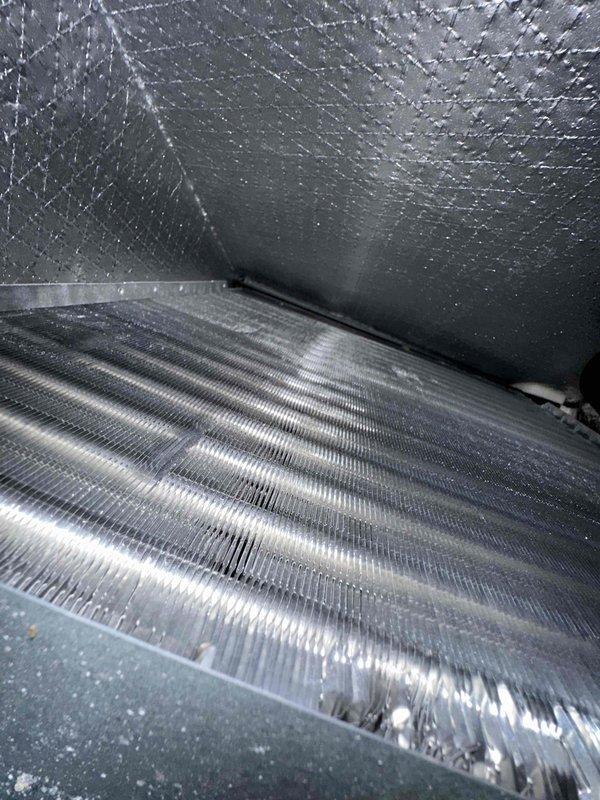 Performed comprehensive preventive maintenance on residential cooling system. Inspected evaporator coil assembly housed within insulated air handler unit, confirming proper fin condition and heat exchange surface integrity. Verified condensate drain line positioning and clearance at coil base. All components found in satisfactory operating condition with no deficiencies noted.