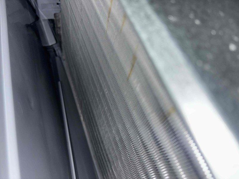 Completed scheduled cooling system maintenance visit. Inspected condenser coil assembly and documented fin condition with minor dust accumulation and discoloration along edges. Replaced 24x25x5 FILTERBUY air filter to maintain proper airflow and system efficiency.