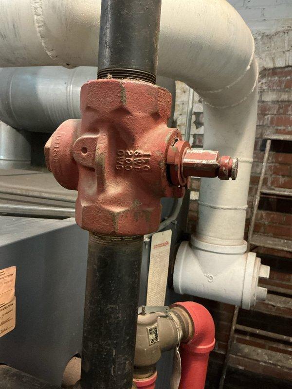 Conducted site assessment for commercial boiler system replacement in a four-story church facility. Inspected existing mechanical room infrastructure, documented electrical panel configuration with dual rows of circuit breakers and main disconnect, and evaluated current boiler piping system including aged cast iron valves, mixed PVC and copper piping assemblies, and shut-off valve locations to determine feasibility and scope of potential replacement project.
