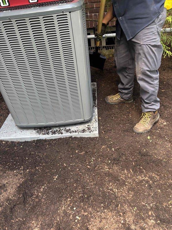 Leveled outdoor condensing unit that had settled unevenly on concrete pad. Used precision level to verify proper positioning and adjusted unit to ensure optimal performance and prevent potential compressor damage from improper orientation. Unit now sits level on pad with correct drainage pitch maintained.