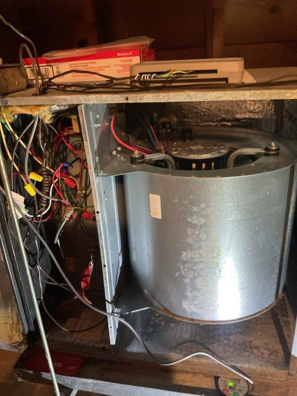 # HVAC Cooling Maintenance Completed

Performed comprehensive preventive maintenance on residential air conditioning system as part of ongoing seasonal maintenance program. Conducted thorough inspection of all electrical connections at terminal block, verifying proper wire terminations and secure connections across all control circuits including power, control, and communication wiring. Inspected blower motor assembly and heat exchanger components, noting normal operational dust accumulation on cylindrical housing. Verified all electrical wire connections within control panel showing secure terminations with appropriate color-coded conductors properly installed. All system components inspected and found operational with no immediate repairs required. Unit ready for continued cooling season operation.