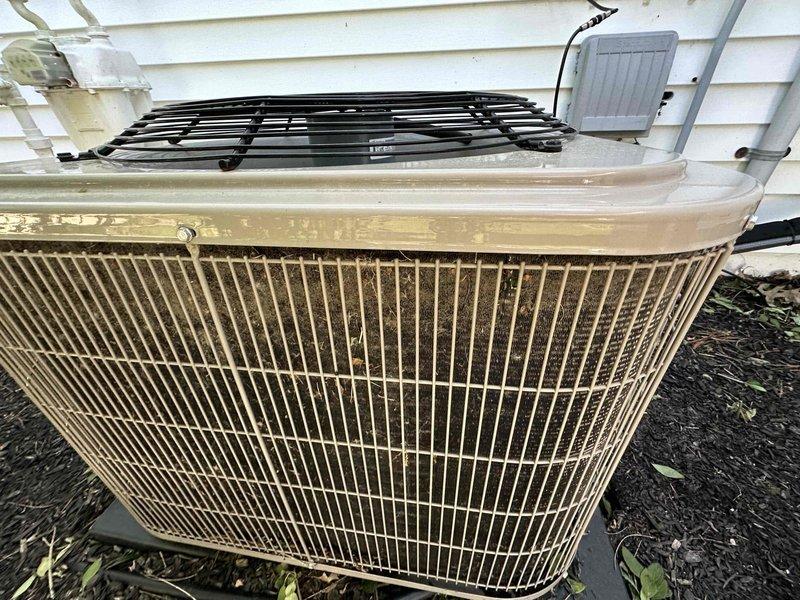 Completed routine HVAC cooling maintenance on residential outdoor condenser unit. Performed standard inspection and maintenance procedures, noting that electrical service had been previously completed. Unit operational with visible weathering and debris accumulation on exterior grille requiring attention during service.