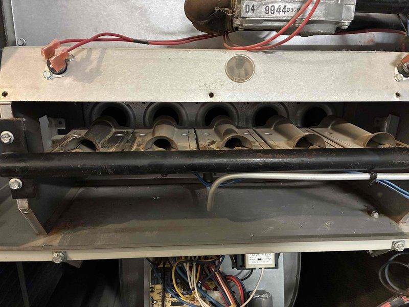 Completed comprehensive heating and cooling tune-up on HVAC system. Performed internal inspection of furnace cabinet, examining burner assembly, heat exchanger components, electrical connections, and wiring harnesses—all components found in serviceable condition. Replaced heavily soiled air filter with significant dust and debris accumulation to restore proper airflow and system efficiency.