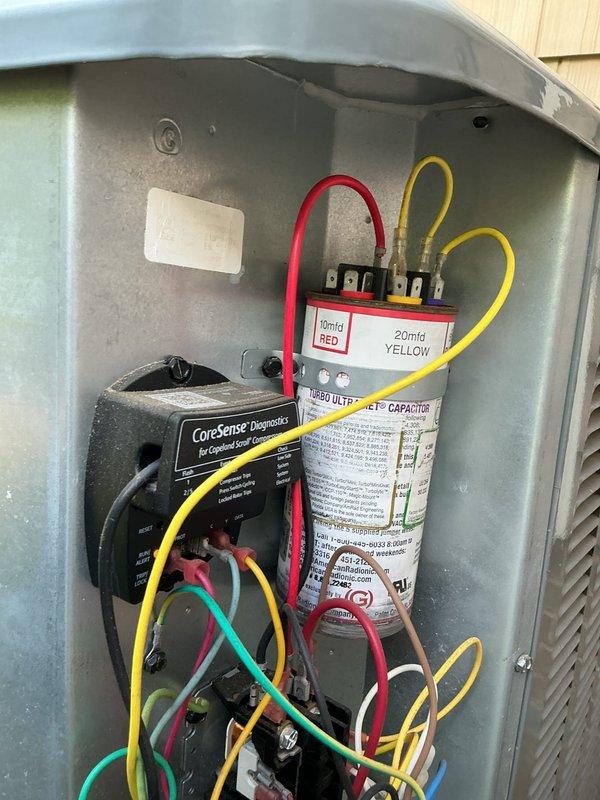 Completed routine preventative maintenance on residential cooling system. Inspected outdoor condensing unit electrical components including disconnect switch, dual-run capacitor, and CoreSense diagnostic module for Copeland Scroll compressor, confirming all connections secure and components operating within normal parameters.