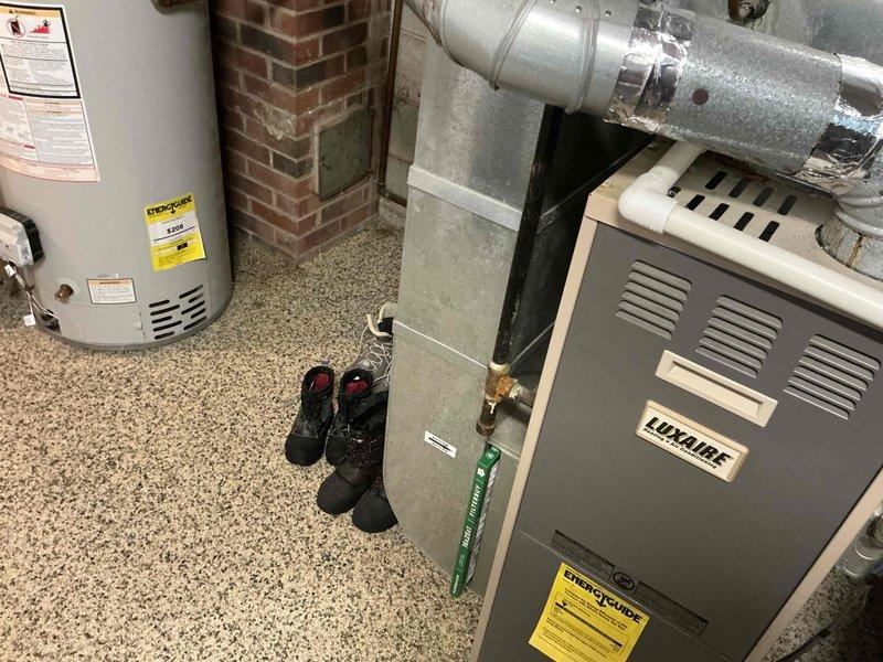 Conducted comprehensive assessment of existing Luxaire furnace and complete HVAC system in basement mechanical room to provide full system replacement options. Documented current equipment conditions including manufacturer specifications, electrical connections, and visible corrosion on metal components and ductwork, noting easy access to installation area for future replacement work.