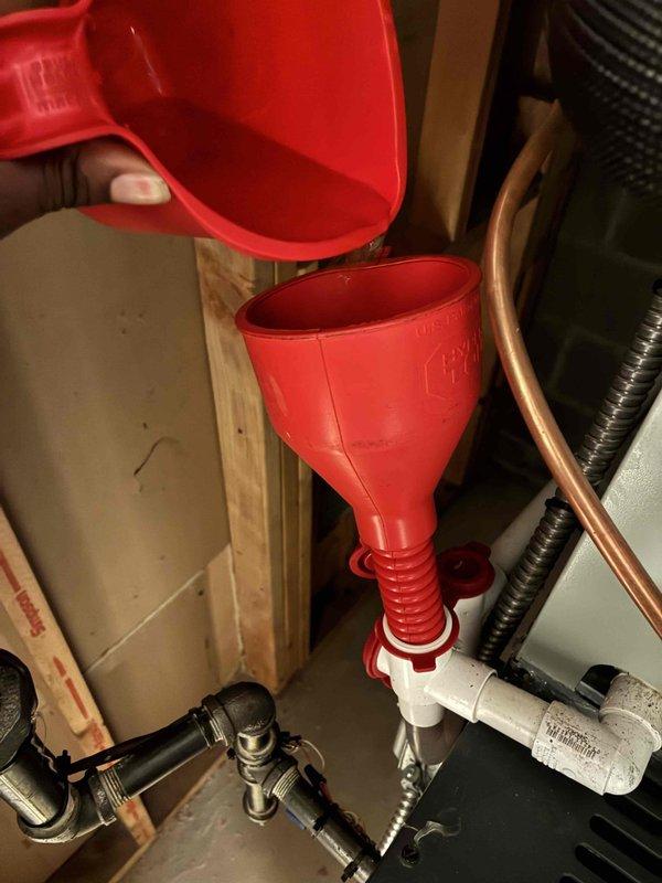 Completed scheduled preventive maintenance on residential air conditioning system. Performed outdoor condenser unit inspection, verified refrigerant levels at service ports, and conducted indoor air handler maintenance including condensate drain line servicing using funnel attachment for proper system operation.