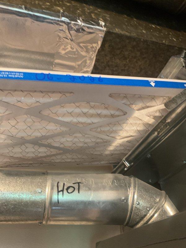 Completed comprehensive cooling system tune-up on Goodman HVAC unit located in basement utility area. Performed standard maintenance procedures including inspection of furnace components, ductwork, and refrigerant lines. Verified air filter condition and confirmed proper airflow through system, with filter showing clean white surface and intact diamond pattern structure.