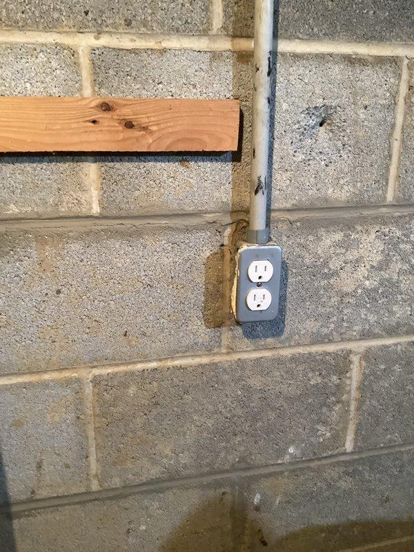Completed comprehensive electrical inspection of residential service panel and basement utility area. Documented existing electrical infrastructure including subpanel with multiple circuit breakers, verified proper conductor routing and connections, and photographed conduit installation with receptacle outlet mounted on concrete block wall. All components were visually inspected and photographed for record-keeping purposes.