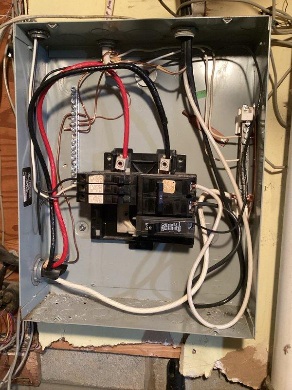 Completed comprehensive electrical inspection of residential service panel and basement utility area. Documented existing electrical infrastructure including subpanel with multiple circuit breakers, verified proper conductor routing and connections, and photographed conduit installation with receptacle outlet mounted on concrete block wall. All components were visually inspected and photographed for record-keeping purposes.