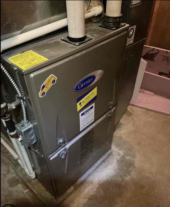 Conducted comprehensive assessment of existing HVAC system for full replacement estimate. Evaluated attic-mounted air handler unit showing signs of age and wear, including deteriorated insulation and discoloration on metal ductwork. Inspected refrigerant lines, condensate drain configuration, and existing support structures. Assessed basement-installed Carrier furnace unit, examining venting system with dual PVC exhaust pipes, gas line connections, and ductwork interface. Documented current equipment specifications and installation conditions to provide customer with multiple full system replacement options.