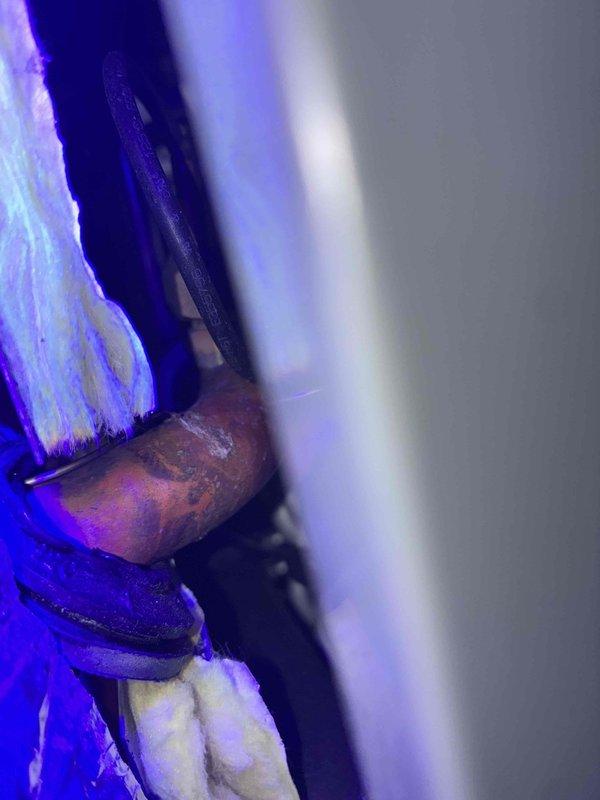 Performed refrigerant leak detection service on HVAC system using UV dye injection method. Inserted fluorescent dye into refrigerant circuit and utilized ultraviolet light inspection to identify potential leak points in copper piping and connections. Inspected accessible copper piping, joints, and fittings in confined wall cavity areas where insulation is present, documenting findings with UV illumination photography for accurate leak location verification.