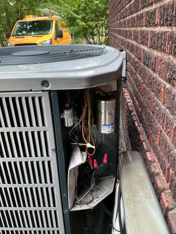 Responded to no cooling complaint on residential air conditioning system. Upon arrival, inspected outdoor condensing unit and found failed dual run capacitor preventing compressor and condenser fan motor operation. Removed access panel, tested capacitor with multimeter confirming zero capacitance on both common and fan terminals. Replaced defective capacitor with proper MFD-rated component, verified all electrical connections secure, and restored power to system. Confirmed compressor and condenser fan motor startup, monitored system operation through complete cooling cycle, and verified proper airflow at indoor air handler. System restored to normal cooling operation.