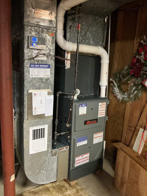 Completed comprehensive cooling maintenance on residential HVAC system consisting of Amana furnace unit with integrated cooling components and associated water heater. Performed standard preventive maintenance procedures including inspection of exterior ventilation grille with seasonal operation markings, verified proper airflow through PVC ventilation piping, and conducted diagnostic measurements using calibrated testing equipment to ensure system operating within manufacturer specifications.