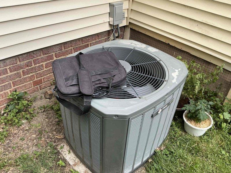 Provided comprehensive HVAC system replacement estimate for small residential cooling system serving 0-1500 square feet with basement unit location. Presented three tiered Goodman air conditioning and coil replacement options with varying efficiency levels: Good tier at up to 13.4 SEER, Better tier at up to 14 SEER, and Best tier at up to 16 SEER. Evaluated existing outdoor condensing unit showing significant age-related deterioration, weathering, and discoloration on exterior casing. Assessed installation site conditions including accessible mounting location against exterior wall with adequate clearance, existing electrical disconnect box and refrigerant line routing, and surrounding landscape considerations for equipment placement and service access.