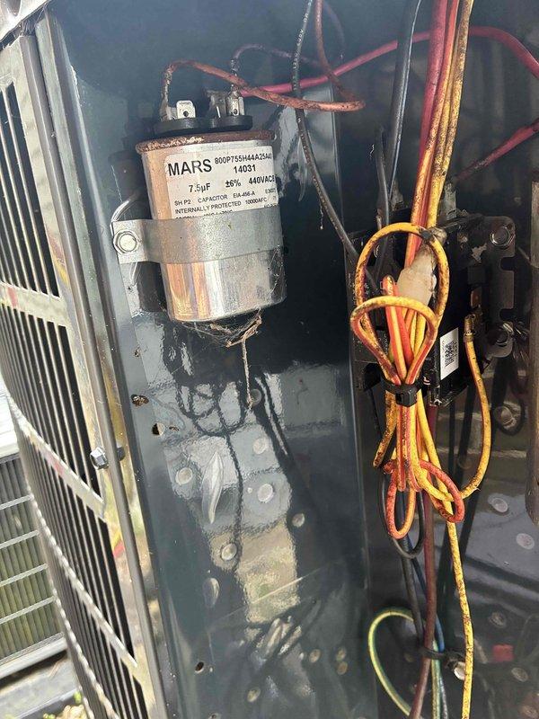 Performed comprehensive cooling maintenance on HVAC system. Upon inspection of the electrical components, identified a severely corroded dual-run capacitor with significant rust and oxidation on the terminal cap and mounting surface, indicating prolonged exposure to moisture and environmental elements. Replaced the failed capacitor with new MARS 7.5μF 440V/AC unit to restore proper compressor and condenser fan motor operation. Verified all electrical connections, inspected condenser coil fins for debris and damage, and tested system operation to ensure proper cooling performance and electrical readings within manufacturer specifications.