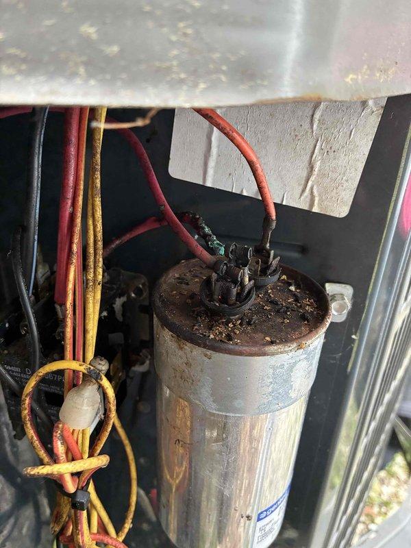 Performed comprehensive cooling maintenance on HVAC system. Upon inspection of the electrical components, identified a severely corroded dual-run capacitor with significant rust and oxidation on the terminal cap and mounting surface, indicating prolonged exposure to moisture and environmental elements. Replaced the failed capacitor with new MARS 7.5μF 440V/AC unit to restore proper compressor and condenser fan motor operation. Verified all electrical connections, inspected condenser coil fins for debris and damage, and tested system operation to ensure proper cooling performance and electrical readings within manufacturer specifications.
