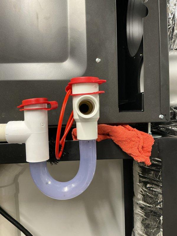 Responded to warranty service call for Daikin system originally installed by another contractor. Customer was referred to our company for warranty support after experiencing a second component failure within a few years of installation. Coordinated with original installing contractor regarding warranty part exchange and return process to distributor. Inspected humidification system components including P-trap assembly with temporary caps and HumidiPRO digital humidity controller showing operational readings. Documented equipment condition and humidifier installation for warranty records.