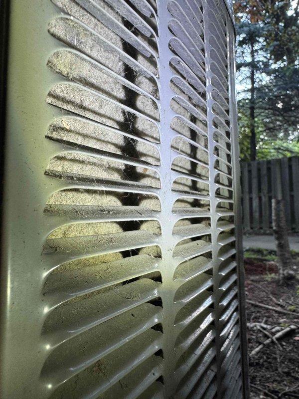 Performed routine HVAC maintenance on outdoor condensing unit. Upon inspection, found exterior coil fins heavily coated with dust, dirt, and debris significantly restricting airflow and reducing system efficiency. Cleaned condenser coil, performed electrical diagnostics with multimeter to verify proper voltage and amperage readings, and replaced air filters per maintenance protocol.