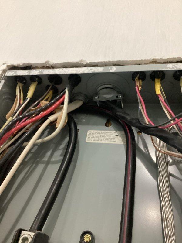 Completed electrical service and repair on HVAC equipment and power management systems. Inspected and verified proper wiring connections at equipment junction box, including red, white, yellow, pink, and black insulated conductors routed through terminal block. Serviced dual power management units with battery backup capability, confirmed operational status with green indicator lights functioning on both devices. Organized and secured electrical conduits and communication cabling. All systems tested and verified operational upon completion.