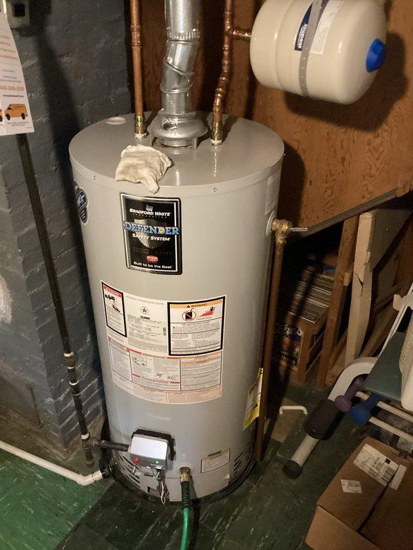 Performed routine maintenance flush on Bradford White tanked water heater to remove sediment buildup and ensure optimal performance. Connected garden hose to drain valve, flushed tank thoroughly until water ran clear, and verified all connections, temperature and pressure relief valve, and copper supply lines were secure and functioning properly.