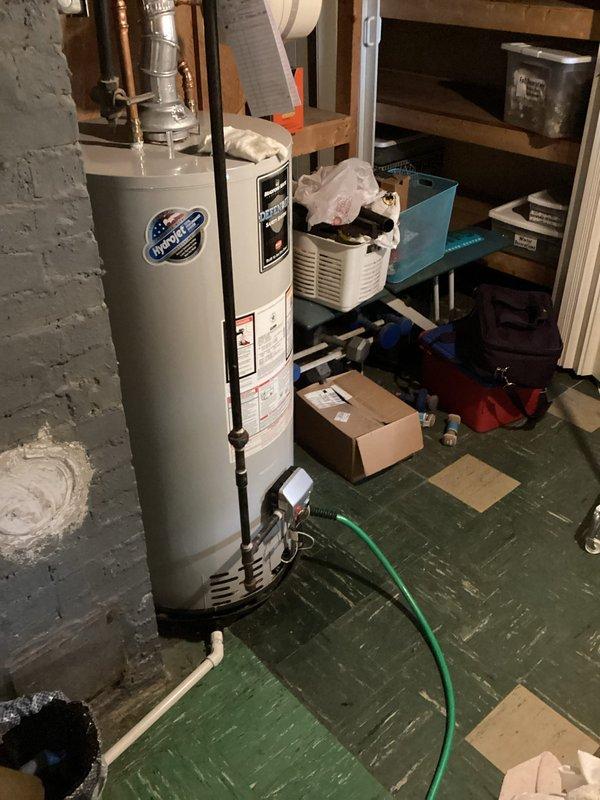 Performed routine maintenance flush on Bradford White tanked water heater to remove sediment buildup and ensure optimal performance. Connected garden hose to drain valve, flushed tank thoroughly until water ran clear, and verified all connections, temperature and pressure relief valve, and copper supply lines were secure and functioning properly.