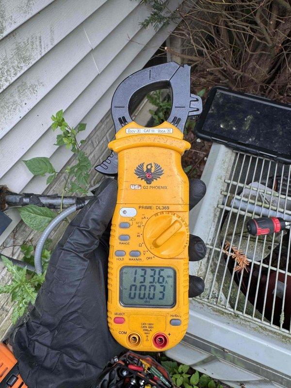 # HVAC Service Report

Responded to no cooling call with outdoor unit fan not operating. Upon arrival, found aging Trane condenser with condenser fan motor failure. Unit showed significant weathering, algae growth, and inadequate clearance from surrounding vegetation. Measured electrical parameters with clamp meter, confirming loss of power to fan motor circuit. System over 10 years old with visible deterioration of cabinet and components. Diagnosed failed condenser fan motor as primary cause of no cooling condition. Collected diagnostic fee and provided customer with repair options for motor replacement and recommended vegetation clearance for proper airflow and unit longevity.