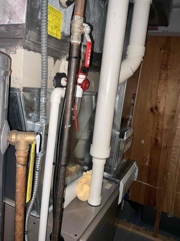 Conducted comprehensive evaluation of existing HVAC system for replacement estimate. Assessed outdoor condensing unit positioned on ground-level pad adjacent to structure, noting current equipment configuration and accessibility for future installation. Evaluated interior mechanical space containing existing air handler, ductwork connections, gas lines with shut-off valves, and associated plumbing infrastructure. Documented system layout including flexible duct runs, copper refrigerant lines, PVC drainage piping, and electrical conduit routing through basement area. Provided customer with replacement options based on site conditions and confirmed easy access for equipment changeout.