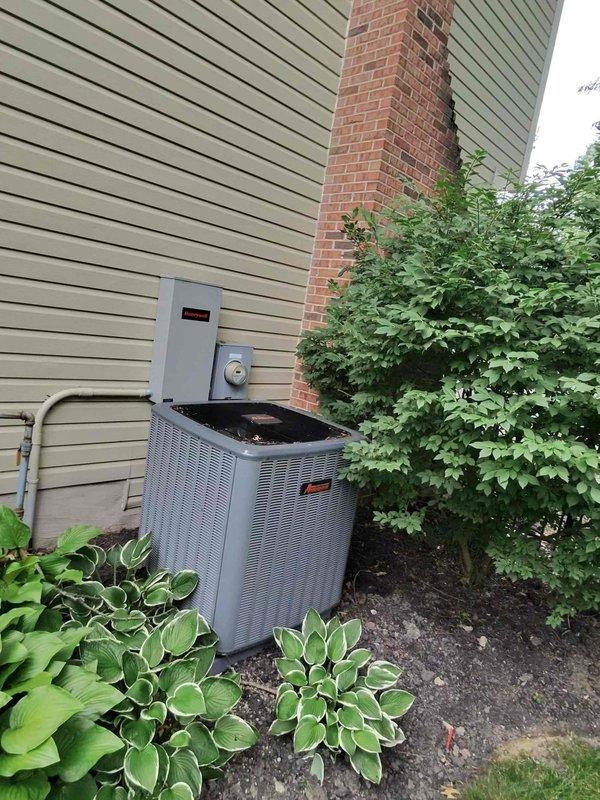 Responded to service call for air conditioning unit producing abnormal loud noise. Upon arrival, performed visual inspection of outdoor condenser unit and accessed electrical compartment to diagnose issue. Removed access panel to examine internal components, wiring connections, and CoreSense monitoring module. Inspected all electrical connections, wire routing, and control systems for loose components or mechanical failures that could generate unusual sounds during operation. Unit assessed and findings documented with photographic evidence of equipment condition and internal configuration.