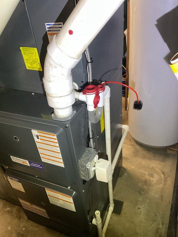 Completed scheduled cooling system maintenance visit on residential HVAC unit located in basement utility area. Performed comprehensive inspection of furnace and air conditioning components, including examination of condensate drain system with red-colored trap and drainage lines. Verified proper operation of all cooling system components, checked refrigerant levels, and inspected ductwork in crawlspace area for proper airflow and connections. All systems operating within normal parameters and ready for cooling season.