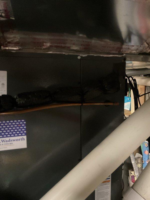 Completed scheduled cooling system maintenance visit on residential HVAC unit located in basement utility area. Performed comprehensive inspection of furnace and air conditioning components, including examination of condensate drain system with red-colored trap and drainage lines. Verified proper operation of all cooling system components, checked refrigerant levels, and inspected ductwork in crawlspace area for proper airflow and connections. All systems operating within normal parameters and ready for cooling season.
