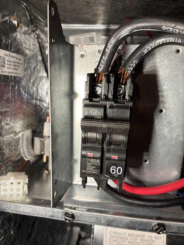 Completed installation of heat pump system with air handler and humidifier. Installed 60-amp double-pole circuit breakers in main electrical panel to provide dedicated power supply for new HVAC equipment. Ran electrical conductors from panel to equipment locations, terminated all connections at breaker terminals and load-side terminal lugs, and verified proper wire sizing and circuit protection for heat pump specifications.