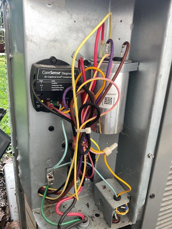 Completed comprehensive cooling system tune-up on residential HVAC unit. Performed standard seasonal maintenance including inspection of electrical control panel with CoreSense compressor diagnostic system, verified proper wiring connections and component functionality, and assessed evaporator coil condition through supply grille. All systems operating within normal parameters.