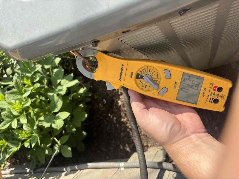 Completed comprehensive cooling system tune-up including performance diagnostics and electrical testing. Verified system operation with temperature differential readings at 93°F and conducted amperage measurements on outdoor condensing unit to ensure proper compressor function and electrical draw within manufacturer specifications.
