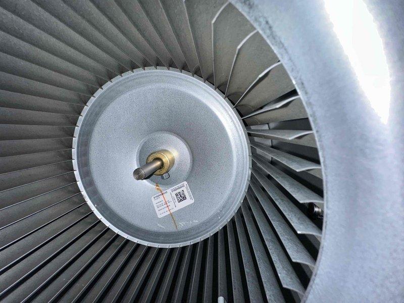 Performed comprehensive cooling system maintenance on HVAC unit. Inspected and documented air filter condition within the air handler, noting the pleated diamond mesh filter properly installed in the metal ductwork housing. Examined blower assembly components, including the centrifugal fan with radial blade configuration and central motor shaft, confirming proper mechanical operation and clearances within the blower housing.