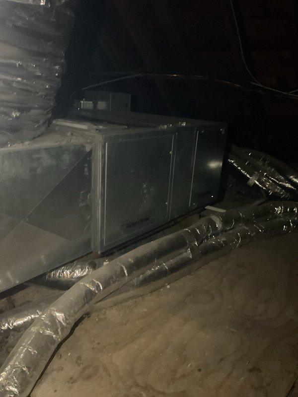 Performed comprehensive cooling system tune-up on attic-mounted green air handling unit. Accessed equipment via side door entry per customer instructions. Completed full preventive maintenance inspection including filter check, coil inspection, electrical connections verification, and refrigerant level assessment. Replaced thermostat batteries to resolve low-battery warning message displayed on control panel. Verified proper airflow through flexible ductwork system and confirmed adequate insulation integrity throughout attic installation. Tested system operation and confirmed unit cycling properly with no abnormal conditions detected. All components functioning within normal parameters upon completion.