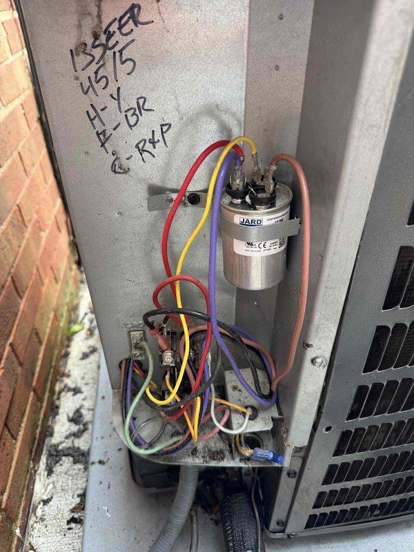 Responded to service call for non-operational air conditioning system. Upon inspection, accessed electrical component panel and control board to diagnose system failure. Evaluated JARD capacitor connections, transformer assembly, and control board wiring terminals. Documented existing system configuration including 13 SEER rating and previous service notations dated 4/5/15. Inspected all wire connections at capacitor terminals and control board, verifying proper routing of power and control wiring throughout the unit. System restored to operational status following diagnostic evaluation and component verification.